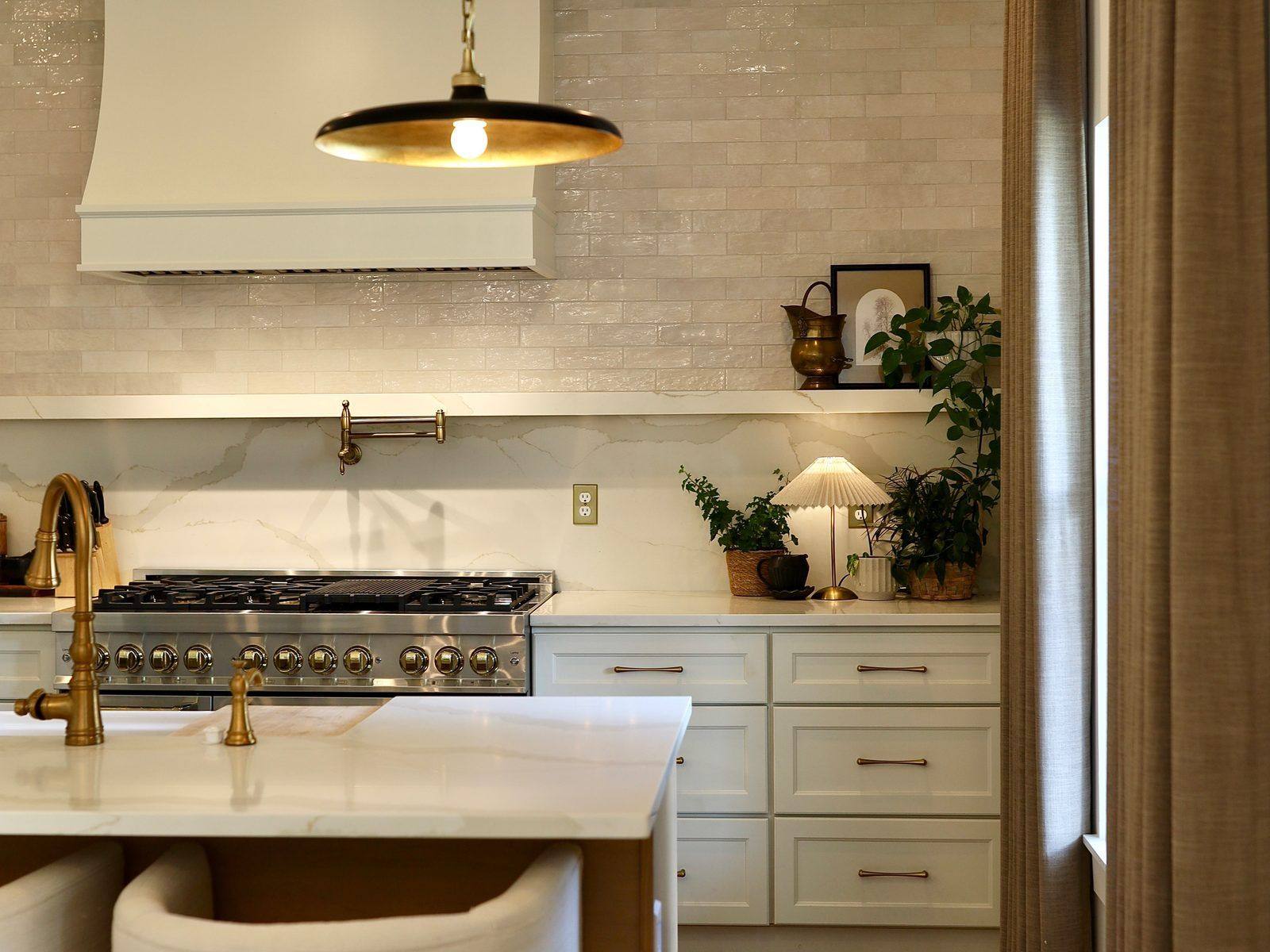 Chef's kitchen at 2454 Brookshire Ave with brass fixtures and marble